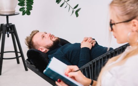 close-up-female-psychologist-writing-down-notes-during-therapy-with-her-male-patient
